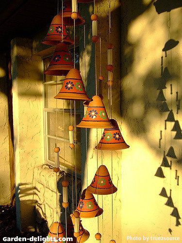  Sand color ceramic porcelain chime bells with orange ring and hand-painted flowers on a hanging spiral mobile wind chime display, ceramic bell chimes, spiral mobile windchimes, ceramic, porcelain windchimes, garden windchimes, nice windchimes.