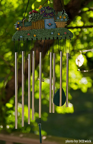 Small tubular ceramic wide wind chimes with four flower baskets filled with colorful(yellow, red, blue) flowers, ceramic wind chimes, decorative hand made windchimes.