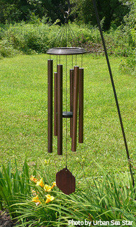 Copper wind chimes weathered with a dark brown color on decorative shepherds hook, contemporary wind chimes, large tube wind chimes.