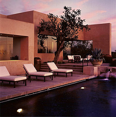Outdoor furniture sets,Modern outdoor furniture, 4 patio lounge chairs by pool in front of modern house.