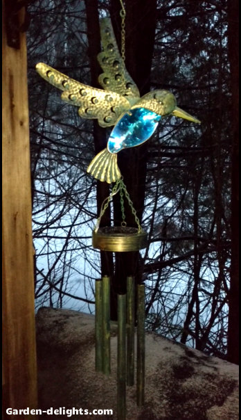  Gold bird with blue electric lights with rotating electric wind chimes on deck looking at trees, battery operated indoor wind chimes, indoor solar chimes, Walmart, solar powered tabletop wind chimes.