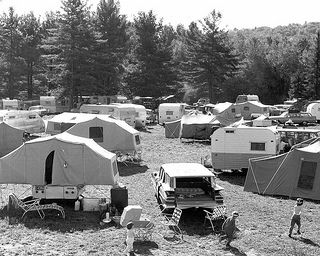Folding Outdoor Furniture, historic campground with tents trailer's in 1961 with kids running by trailers and a car.
