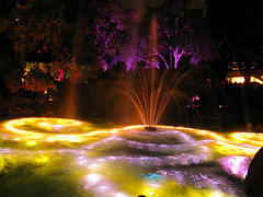 Outdoor fountains spraying in the air with colorful lights, lighted outdoor water fountains, outdoor fountain lights.