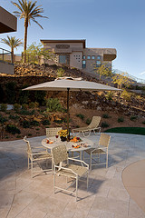 Metal Outdoor garden furniture, beige metal outdoor furniture with umbrella set on hillside.