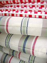 Outdoor Furniture Cushions, striped red and white patio furniture cushions stacked.