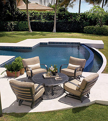 outdoor furniture tips, four piece Wicker patio furniture set in front of pool on patio.