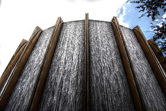 Outdoor waterfall wall fountain with cement pillars separating each waterfall, large wall water fountains, outdoor water features.