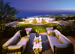 Contemporary Outdoor Furniture, two modern long couches with center table looking out over pond structure to the ocean.