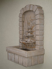 Tall wall mounted shelf contained water fountain with small three-tier design inside, wall-mounted water fountains, self-contained stone wall water fountains.