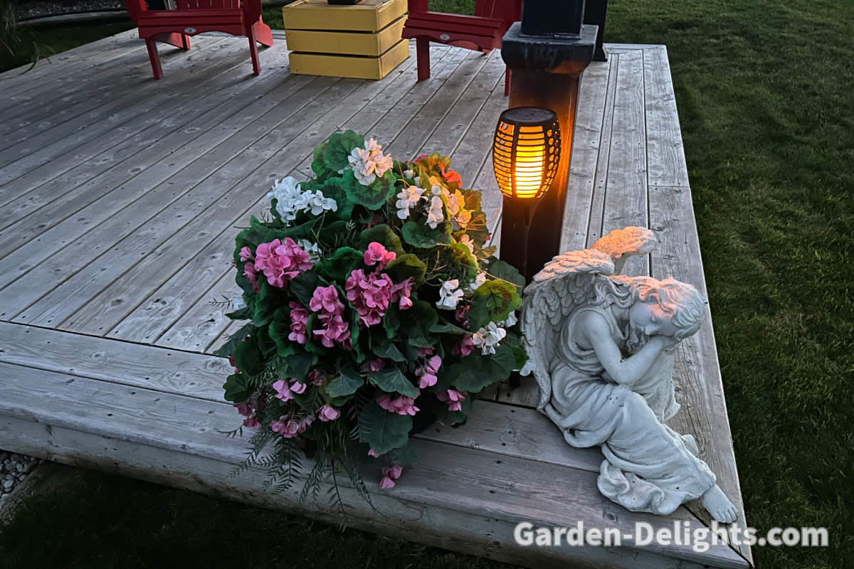  Dancing flickering flame torch light on garden deck with angel and flowers, Realistic led Lights.