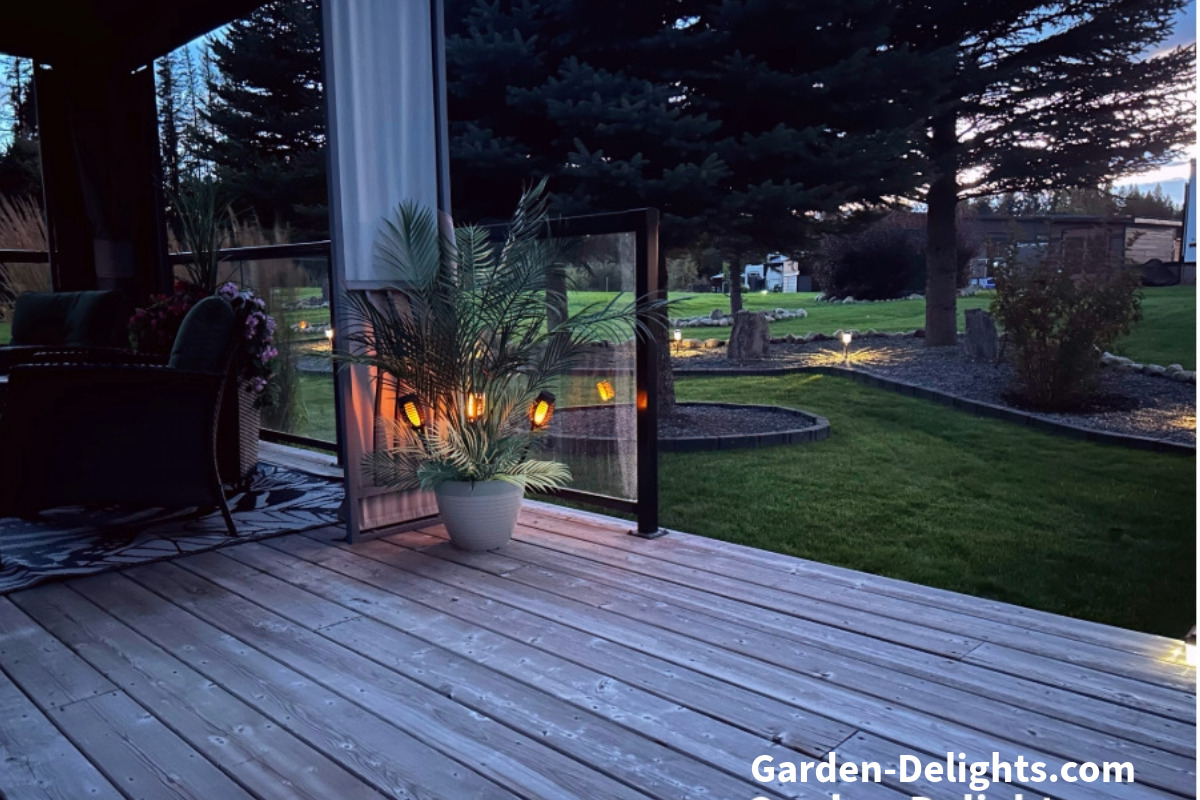  Waterproof solar lanterns with flickering flame lights in a flower pot on a deck, ideal for patio lighting.