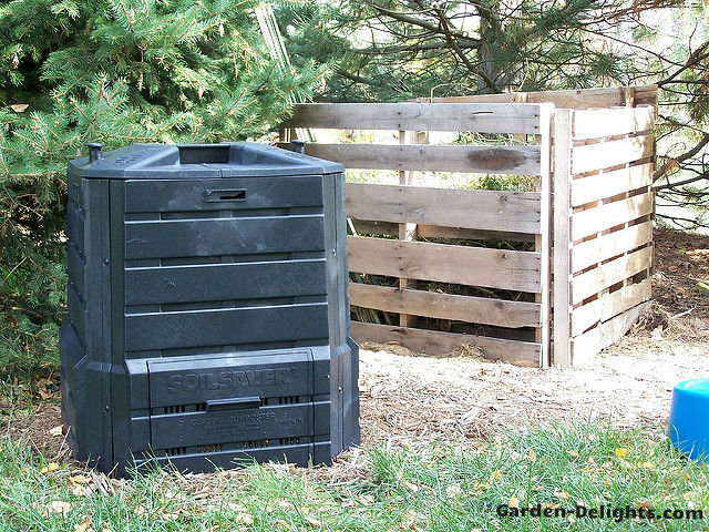 Black plastic compost bin beside a wooden pallet compost bin in the yard,compost bins,homemade compost bins, compost pail.